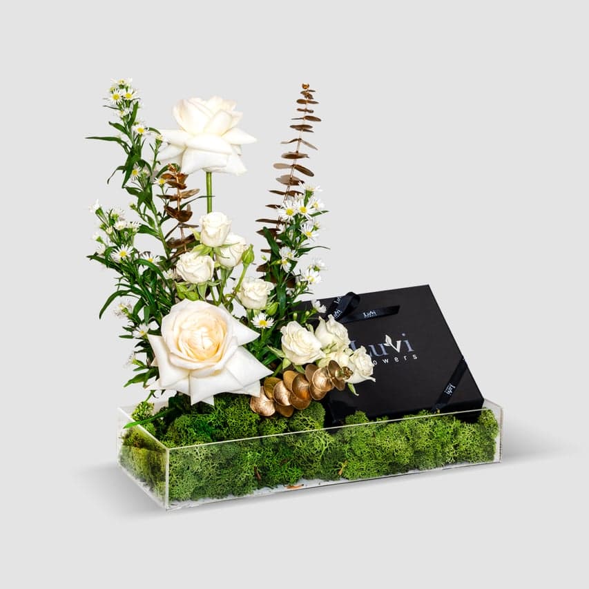 Hilal Al Zahra floral gift with white roses and chocolates.