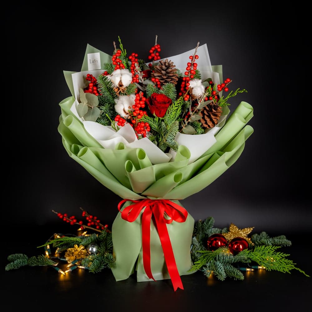 تنسيق زهور البهجة بحجم متوسط يعرض مزيجًا احتفاليًا من الورود الحمراء وعناصر العطلة thumbnail