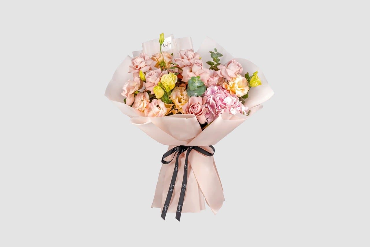 Medium Lovely Lush bouquet with a mix of pink and peach flowers	