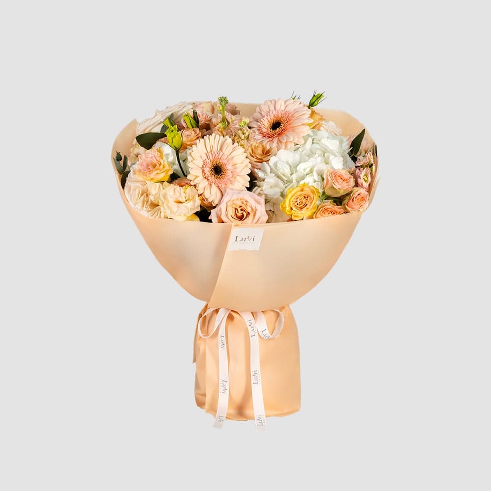 Peach Perfect bouquet featuring peach gerberas, white hydrangeas, white Ohara roses, peach spray roses, peach matthiola, and eucalyptus	