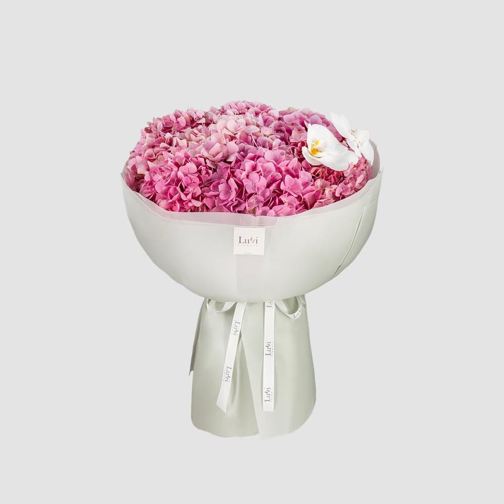 Inspiring Blooms arrangement with hydrangeas and white orchids. thumbnail