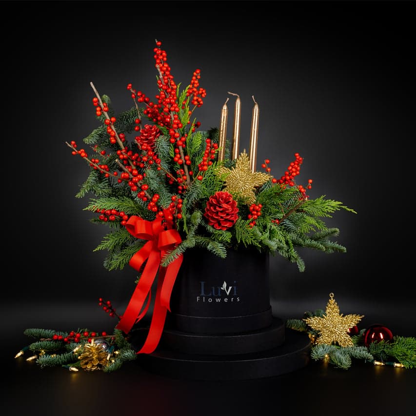 Medium-sized Jolly Holly arrangement showcasing a cozy blend of candles and festive elements	