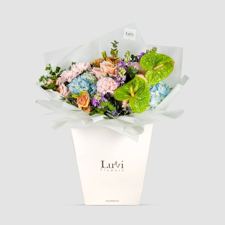 Birthday Bliss bouquet festively presented in a Luviflowers celebratory gift bag	