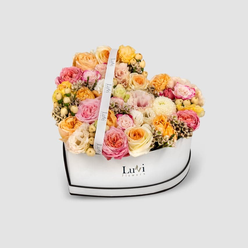 Hubb Al-Um – White hypericum, roses, and lisianthus in a heart-shaped box.