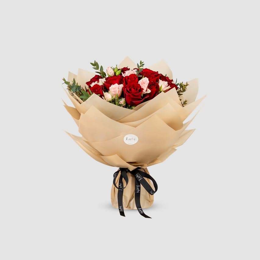 Small Valentina bouquet with pink spray roses, red roses, and eucalyptus. 