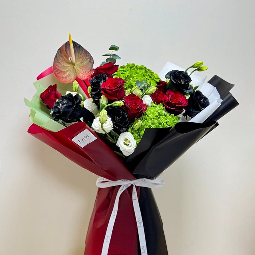 Large Heritage Blooms arrangement showcasing a luxurious mix of red roses, green hydrangeas, white lisianthus, and anthuriums	